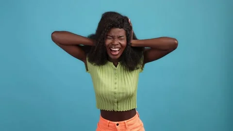 Frustrated lady close ears try ignore fight isolated blue color background Stock Footage 166900963