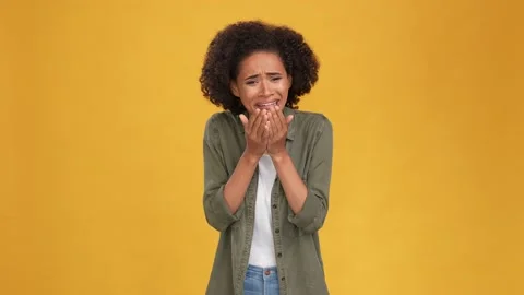 Frustrated lady cry sever close face hands isolated mustard color background Stock Footage 166161915