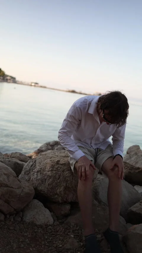 Frustrated man cannot relax on vacation because he keeps thinking about work Stock Footage 341621775