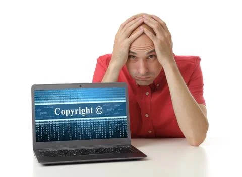 Frustrated man with laptop. copyright concept Stock Photos