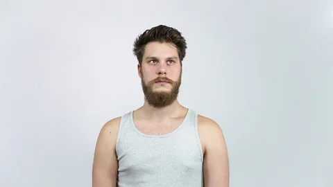 Frustrated man looking at the camera.A young guy with a beard in depression. Stock Footage 122442277