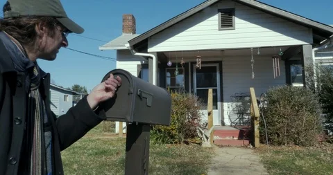 Frustrated man opens his mailbox and looks in to see that it is empty Stock Footage 109583050