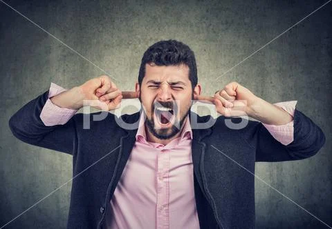 Frustrated man plugging his ears with fingers Stock Photos
