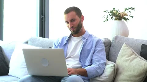 Frustrated man scratching his head while working on a laptop computer Stock Footage 345115210