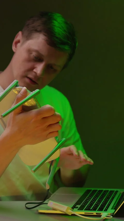Frustrated man shaking wireless router with antennas for better internet Stock Footage 342807975