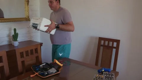 Frustrated man throwing away a broken old printer Stock Footage 336950457