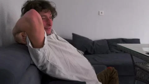 Frustrated man throws computer, Male individual hits laptop in anger, Caucasian Stock Footage 331281148