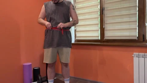 Frustrated Man Throws Tape After Waist Measurement at Home Stock Footage 310871695