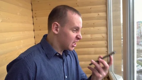 Frustrated man yelling at his smartphone Stock Footage 74753159