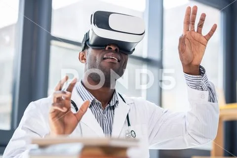 Frustrated medical worker testing VR mask Stock Photos