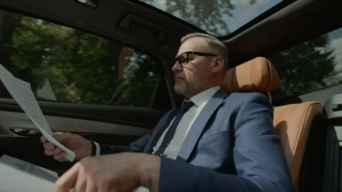Frustrated Middle Aged Businessman Crumpling Financial Document in Car Stock Footage 343387971