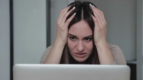 Frustrated millennial female student feel stressed look at computer screen worri Stock Footage