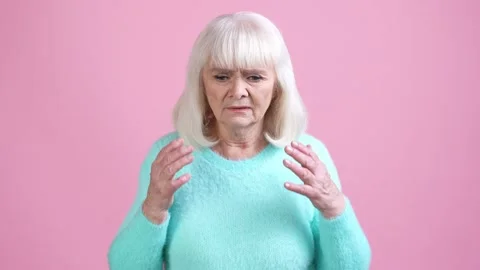 Frustrated old lady not remember mind isolated pastel color background Stock Footage 169289418