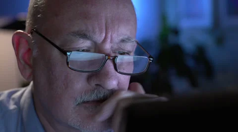 Frustrated older man at computer, close up Stock Footage
