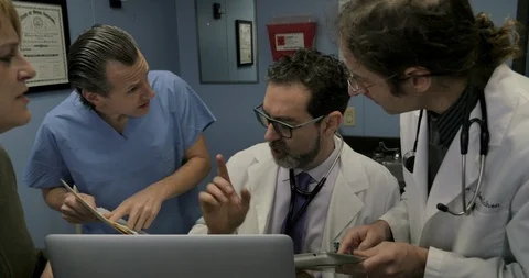 Frustrated overworked doctor multitasking while being interrupted 스톡 동영상 102347234