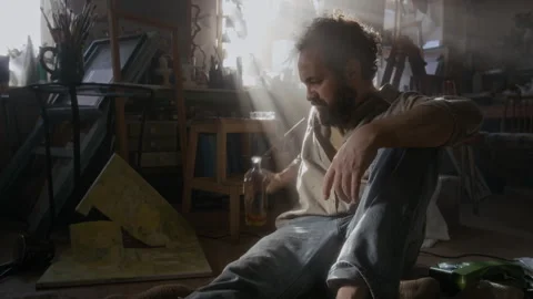 Frustrated Painter Drinking Alcohol after Destroying Artwork in Messy Studio Stock Footage 334686835