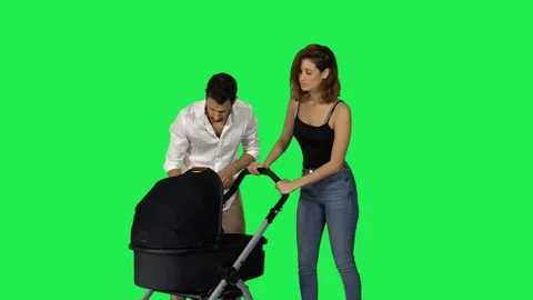 Frustrated parents pushing a stroller with a crying baby Stock Footage 99624850