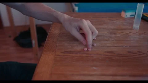 Frustrated Person Counts Medication Before Sweeping Pills Off Table in Anger Stock Footage 341626837