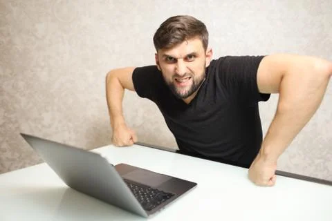 A frustrated person working at a computer Foto stock