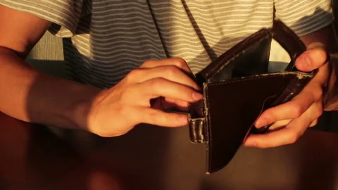 A frustrated poor man throwing a purse and small money on the table Stock Footage 91725682