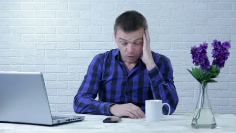 Frustrated with problems young businessman working on laptop computer Video stock 99356620