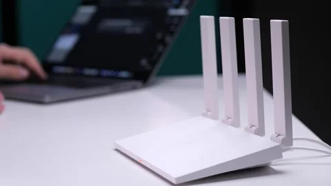 Frustrated programmer hitting wireless router while working on laptop Stock-Footage 302224007