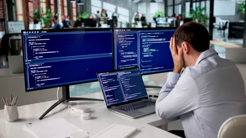 Frustrated Programmer Sitting Alone In Office Working Video stock 335453204