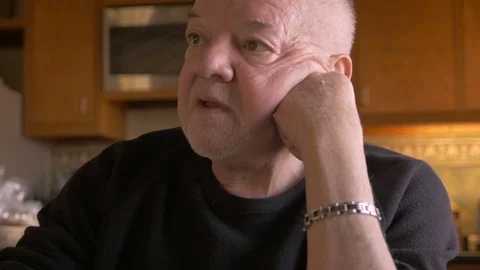 A frustrated senior man talking in front of pill bottles in slow motion Stock Footage 71722718