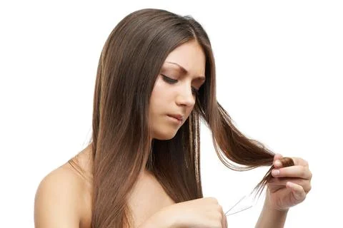 Frustrated by split ends. A beautiful young woman frustrated by her split ends Stock Photos