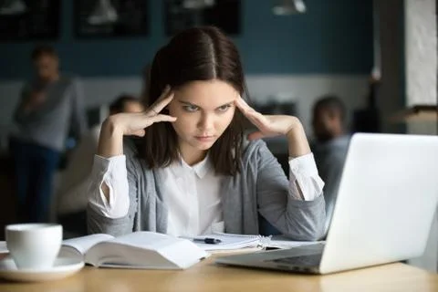 Frustrated stressed student learning difficult exam with laptop 스톡 사진