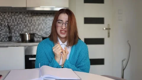 Frustrated student tears notebook page during emotional breakdown Stock Footage 328043037