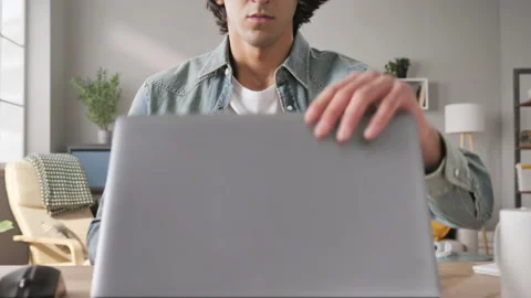 Frustrated upset man sits at his desk opens laptop failure concept Stock Footage 148732385