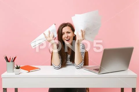 Frustrated woman in desperation crying spreading hand hold paper documents work Stock Photos