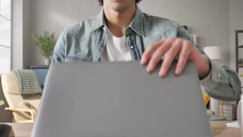 Frustrated young arab man opens laptop computer is disappointed Stock Footage 168883920