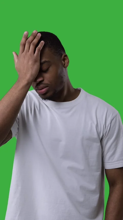 Frustrated young Black man doing a facepalm gesture on a green screen. Stock Footage 328126151