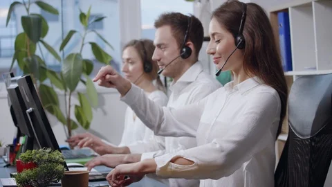 Frustrated young call center operators acting crazy, mad laughing and Stock Footage 110844614