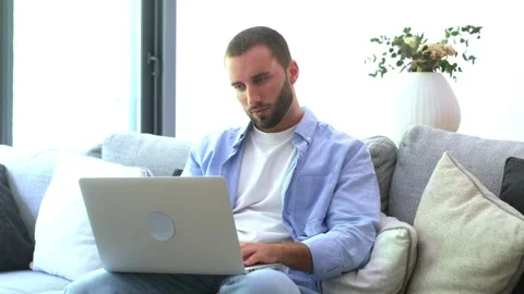 Frustrated young man dealing with computer problems, feeling stressed and tired Stock Footage 345115296