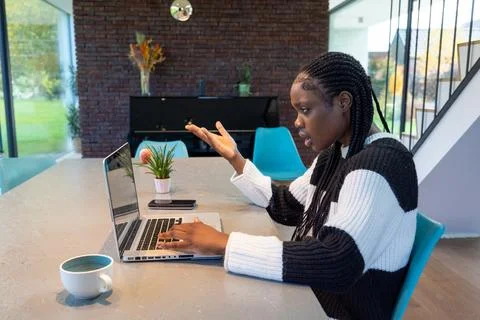 Frustrated Young Professional Dealing with Computer Issues at Home 스톡 사진