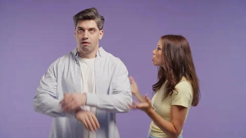 Frustrated young woman arguing while man dismisses her words with mocking blah b Video stock 340988170