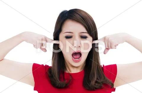 Frustrated young woman with fingers in her ears Stock Photos