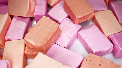 Frutty sof fruit caramel candy candies closeup texture rotating video background Stock Footage 113144537