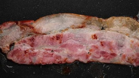 Fry Bacon close up. Bacon slices in frying pan, top view Stock Footage 160249677