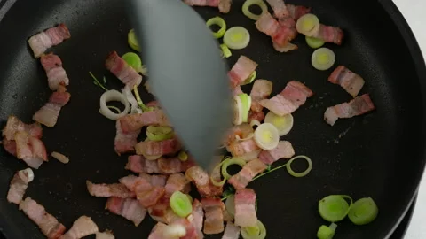 Fry bacon with leeks and butter in a frying pan. Stock Footage 153407705