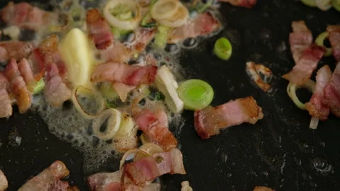 Fry bacon with leeks and butter in a frying pan. Stock Footage 153407899