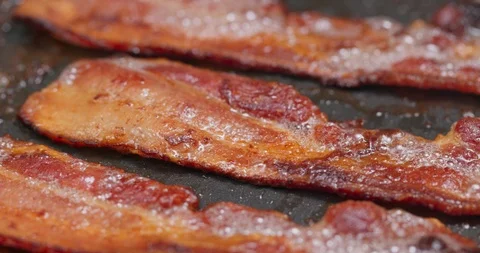 Fry bacon in pan in kitchen for breakfast Stock Footage 114423517