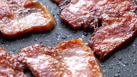 Fry the Bacon Pieces in a Pan. Crispy Pieces of Delicious Bacon are Fried in a Stock Footage 171819324
