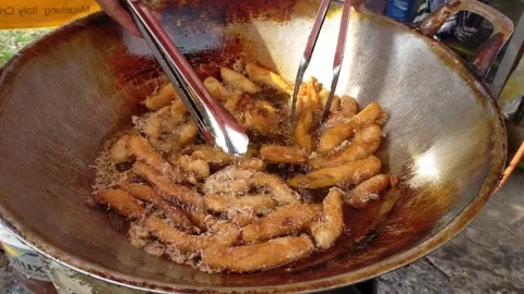 Fry bananas coated in flour for crispy bananas. Stock Footage 255429068
