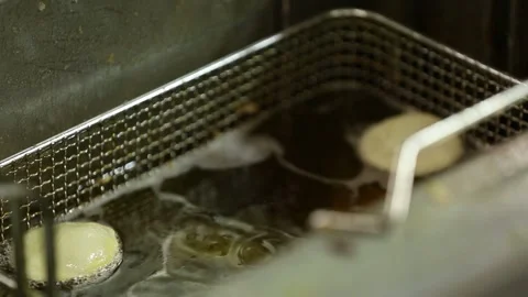Fry bread in oil 1 Stock Footage 312956392