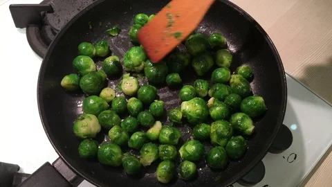 Fry brussels sprouts in a frying pan Stock Footage 83878867