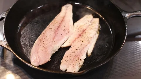 Fry Coooking Red Fish White Meat on Cast Iron skillet video Stock Footage 137744486